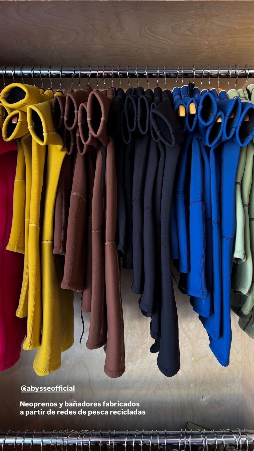 rack of kids springsuits different colors