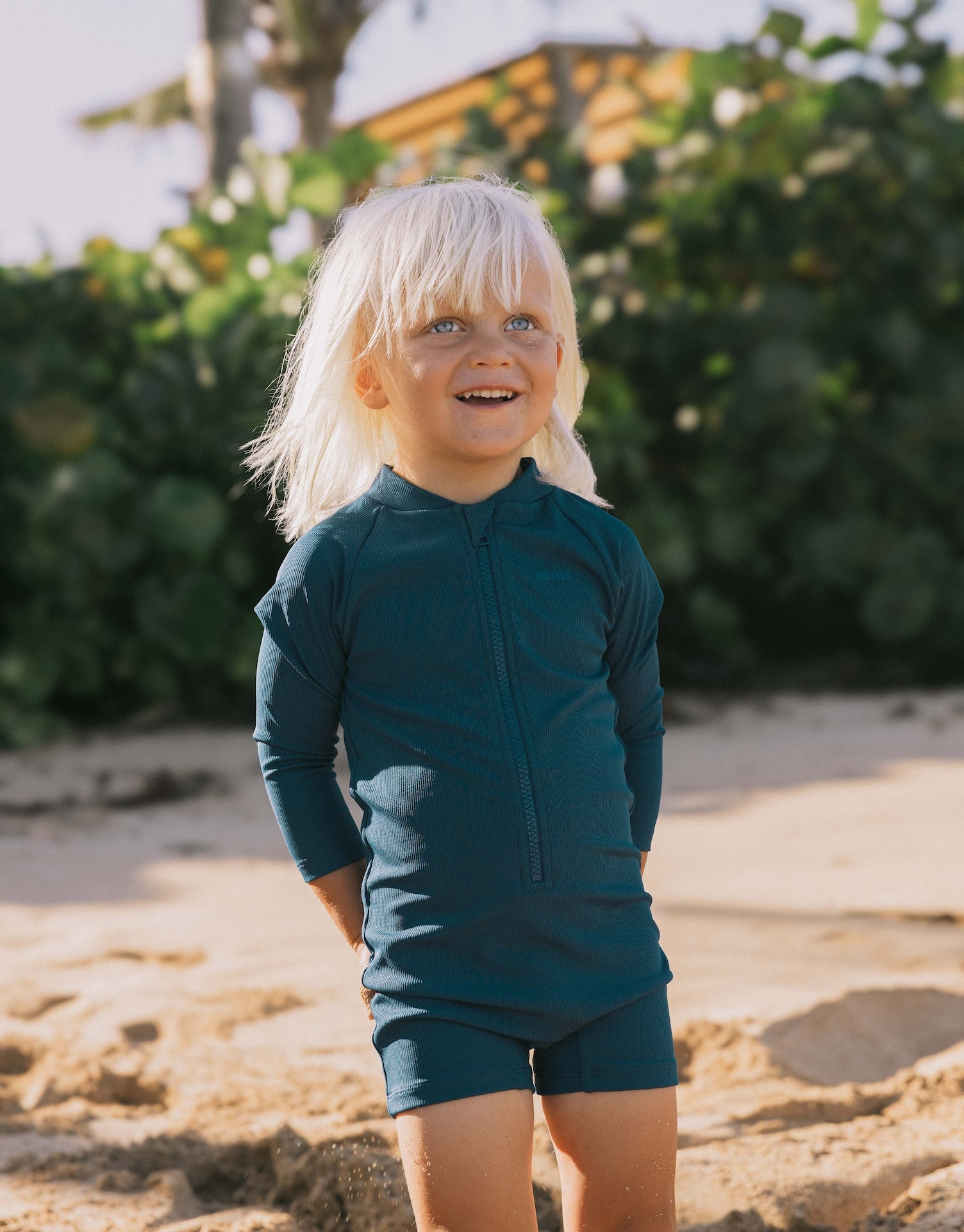 Introducing the Mini Dekker Surf suit, a long sleeve one-piece rash guard, with boy cut shortie bottom.