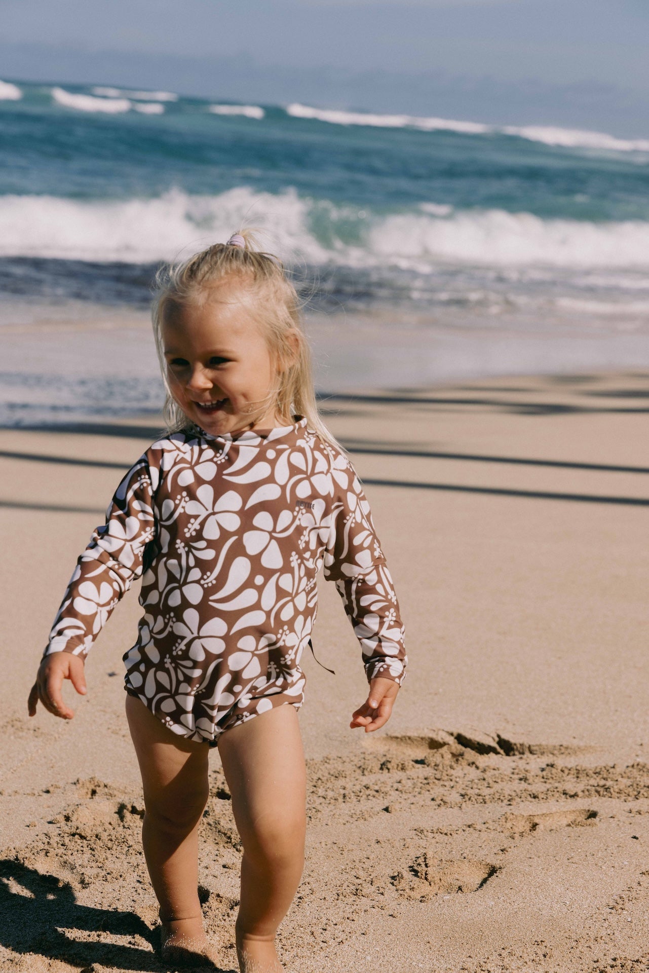 Introducing the Mini Ama Surf suit, a long sleeve one-piece swimwear, made to protect your little ones from the sun during long days at the beach