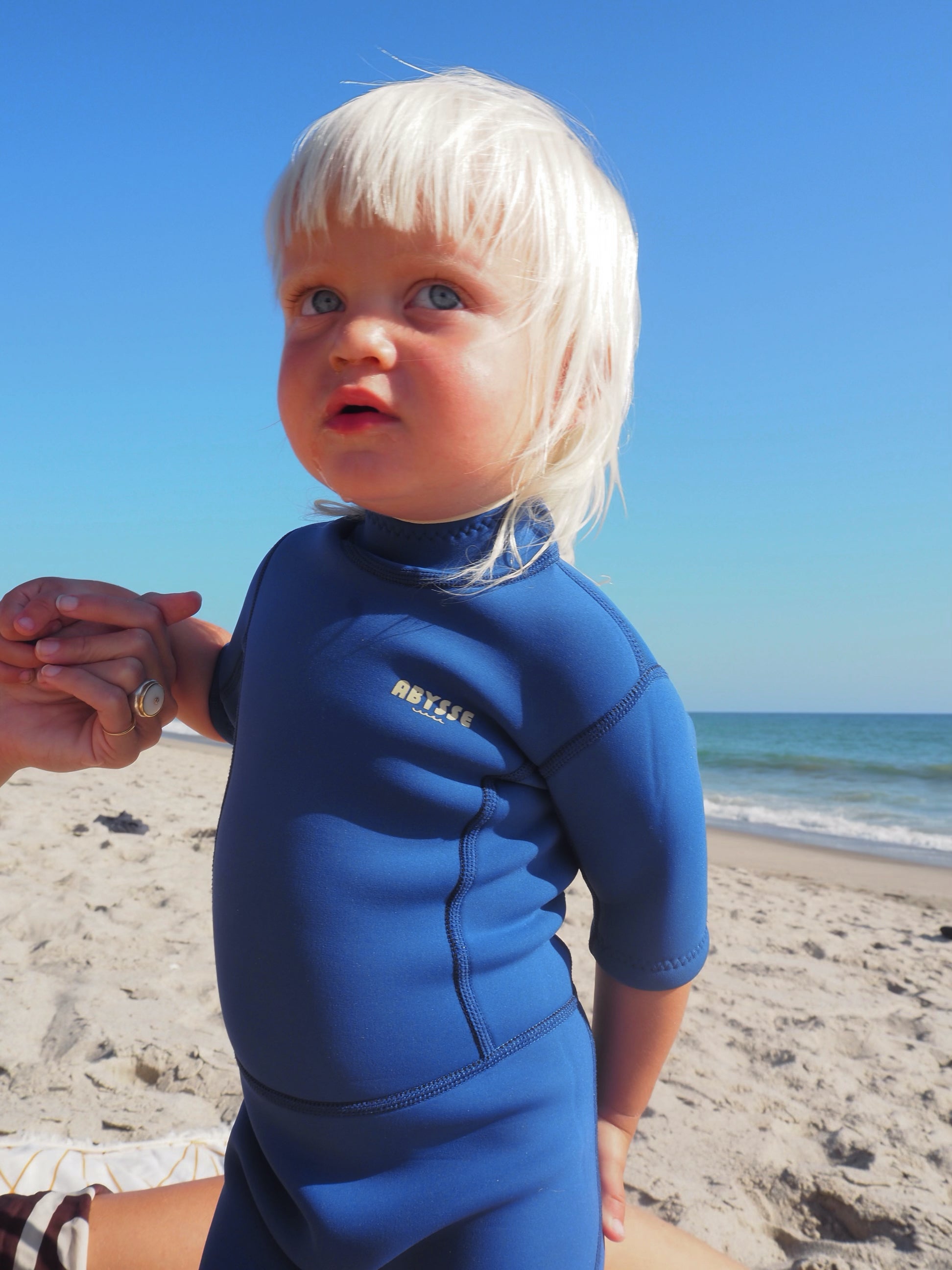 kids wearing a sustainable wetsuit
