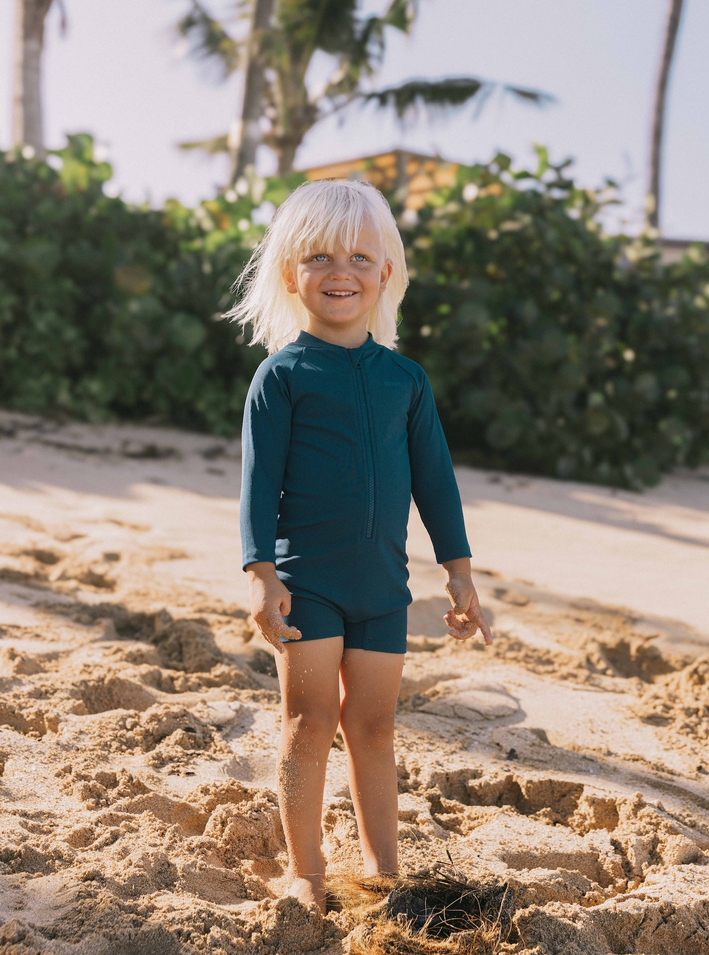 Introducing the Mini Dekker Surf suit, a long sleeve one-piece rash guard, with boy cut shortie bottom.
